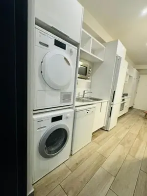 a kitchen with a washing machine and a sink at Acoustic Apartment in Pretoria