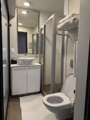a bathroom with a toilet and a sink at Acoustic Apartment in Pretoria