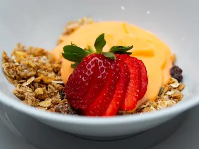 a bowl of food with strawberries and ice cream at Relmies Place in Modimolle
