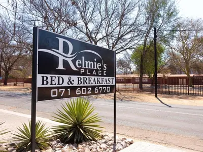 a sign for a bed and breakfast on the side of a street at Relmies Place in Modimolle