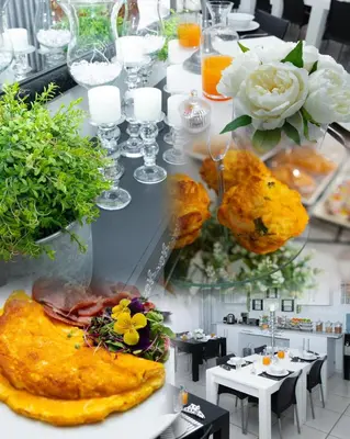 a dining room with a table with food and flowers at Relmies Place in Modimolle