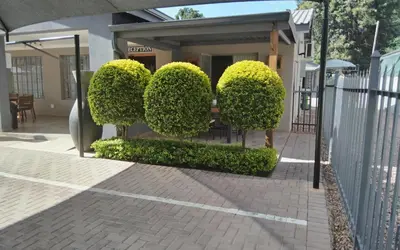 a bush shaped like the word love in front of a house at Relmies Place in Modimolle