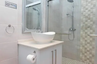 a bathroom with a sink and a shower at Relmies Place in Modimolle