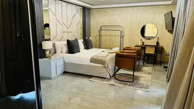 a bedroom with a bed and a desk and a chair at Mercy Boutique Hotel in Thohoyandou