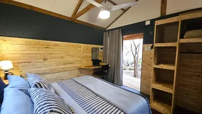a bedroom with a bed with a wooden wall at Marepe Flora Bell mimosa in Kampersrus AH