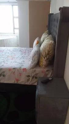 a bed with two pillows on it in a room at Thiwani Guest House in Kempton Park