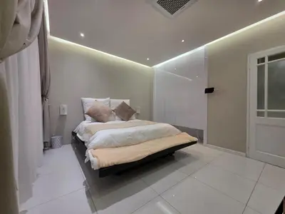 a bedroom with a bed with a light on the ceiling at Hatfield on Park A in Pretoria