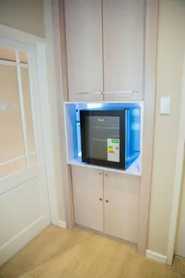 a tv in a corner of a room with a wall at Hatfield on Park A in Pretoria