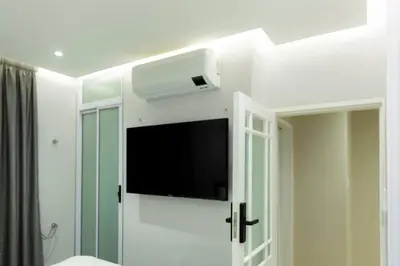a room with a flat screen tv on a wall at Hatfield on Park A in Pretoria
