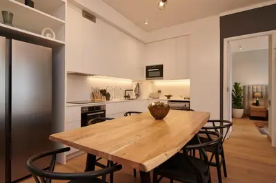 a kitchen and dining room with a wooden table and chairs at When Away - Your Home Away from Home in Pretoria