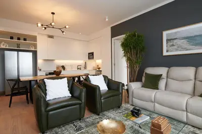 a living room with a couch and a table at When Away - Your Home Away from Home in Pretoria