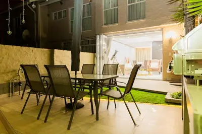 a dining room table and chairs in a room at Hatfield on Park B in Pretoria