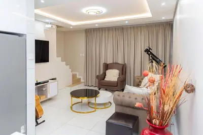 a living room with a couch and a table at Hatfield on Park B in Pretoria