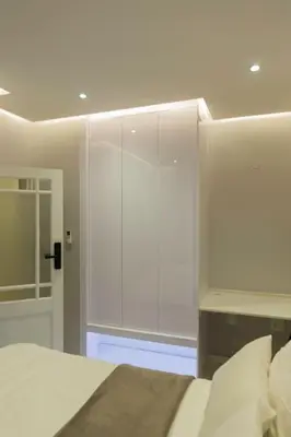 a bedroom with a bed and a large glass closet at Hatfield on Park B in Pretoria
