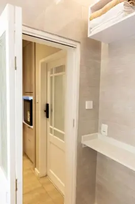 a room with a hallway with a door and a shelf at Hatfield on Park B in Pretoria