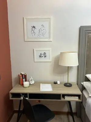 a bedroom with a desk with a lamp and a bed at Galaxy Retreat in Pretoria