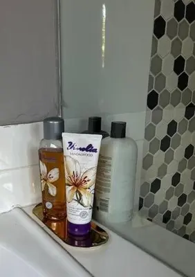 a bathroom counter with two bottles of soap and toiletries at Galaxy Retreat in Pretoria