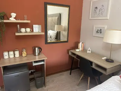 a room with a desk and a mirror at Galaxy Retreat in Pretoria