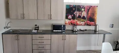 a kitchen with a counter top with a microwave at Pearlman Loft in Tzaneen