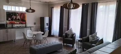 a living room with a couch and a table at Pearlman Loft in Tzaneen