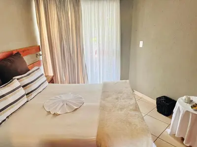 a bedroom with a large bed with a flower on it at Soaring Summit Lodge in Ronaldsey