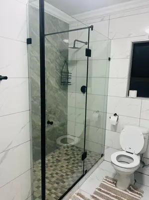 a bathroom with a toilet and a glass shower at KT Comfort in Midrand