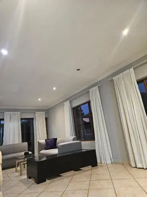 a living room with a couch and some windows at Feel at Home in Monavoni