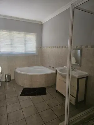 a bathroom with a tub and a sink at Feel at Home in Monavoni