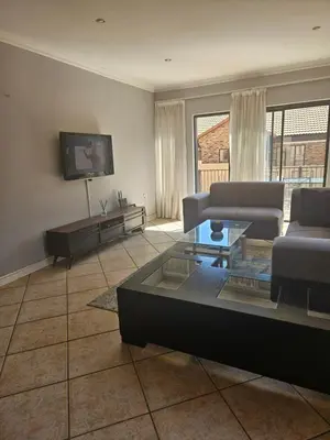 a living room with a couch and a table at Feel at Home in Monavoni