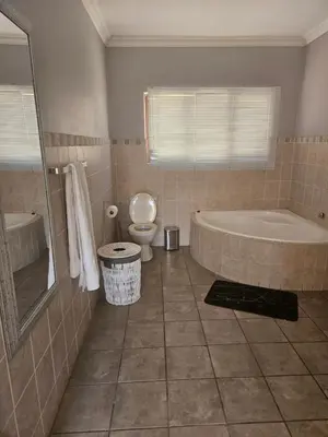 a bathroom with a tub and a toilet at Feel at Home in Monavoni