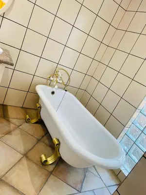 a white toilet in a bathroom with a tiled wall at Melodie Guest House in Lone Star Texas