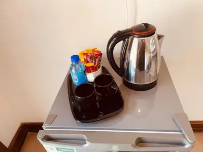 a tea kettle and cups on top of a refrigerator at Melodie Guest House in Lone Star Texas
