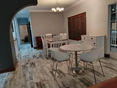 a kitchen and dining room with a table and chairs at Melodie Guest House in Lone Star Texas