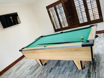 a pool table sitting in a living room with afits at Melodie Guest House in Lone Star Texas