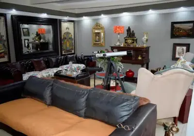 a living room with a leather couch and chairs at The Zebra Suite at Frederick's Place in Pretoria