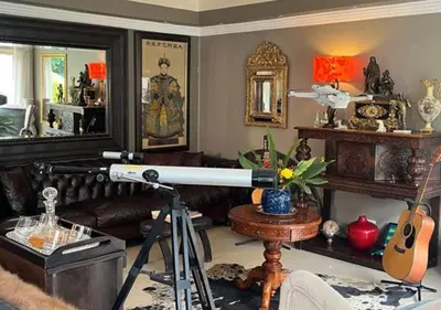 a living room with a telescope in a room at The Zebra Suite at Frederick's Place in Pretoria