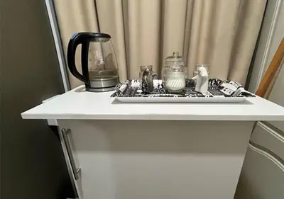 a white table with a tray on top of it at The Zebra Suite at Frederick's Place in Pretoria