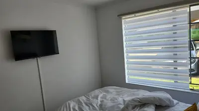 a bedroom with a bed and a television on a wall at Moon Octave in Midrand