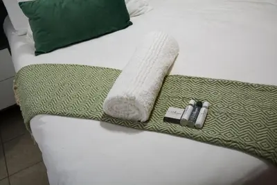 a bed with a towel and two batteries on it at Moon Octave in Midrand