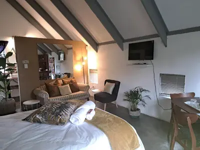 a bedroom with a bed and a living room at Casa Mana Air B&B in Pretoria