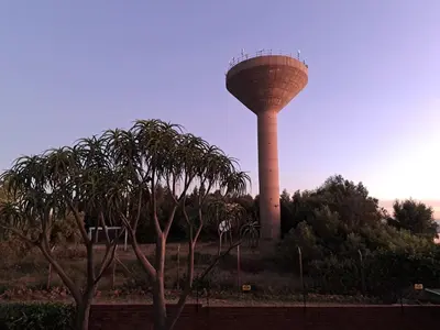 a water tower with palm trees in front of it at Casa Mana Air B&B in Pretoria