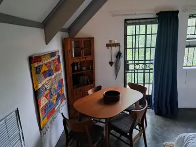 a dining room with a table and chairs and a window at Casa Mana Air B&B in Pretoria