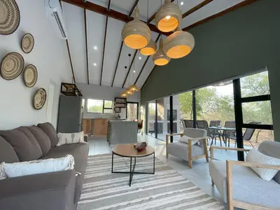a living room with a couch and a table at Shomoro Rest in Marloth Park
