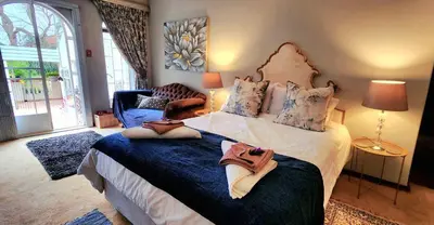a bedroom with a large bed with shoes on it at Harmony Suite in Pretoria
