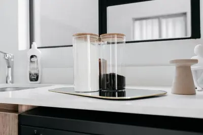 a glass container on a counter with two candles in it at The Blyde Crystal Villa Apartment in Pretoria