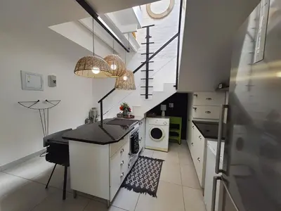 a kitchen with a sink and a washing machine at Fever Tree View in Hartbeespoort