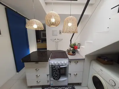 a kitchen with a stove and two hanging lights at Fever Tree View in Hartbeespoort
