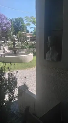 a statue of a woman sitting next to a fountain at 29onTait Guest House in Pretoria