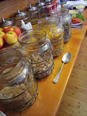 a table with many jars of food on it at 29onTait Guest House in Pretoria