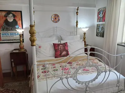 a bedroom with a white bed with a canopy at 29onTait Guest House in Pretoria